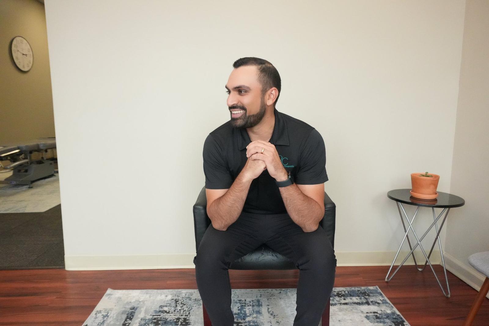 Dr. Neal Surani seated in the clinic